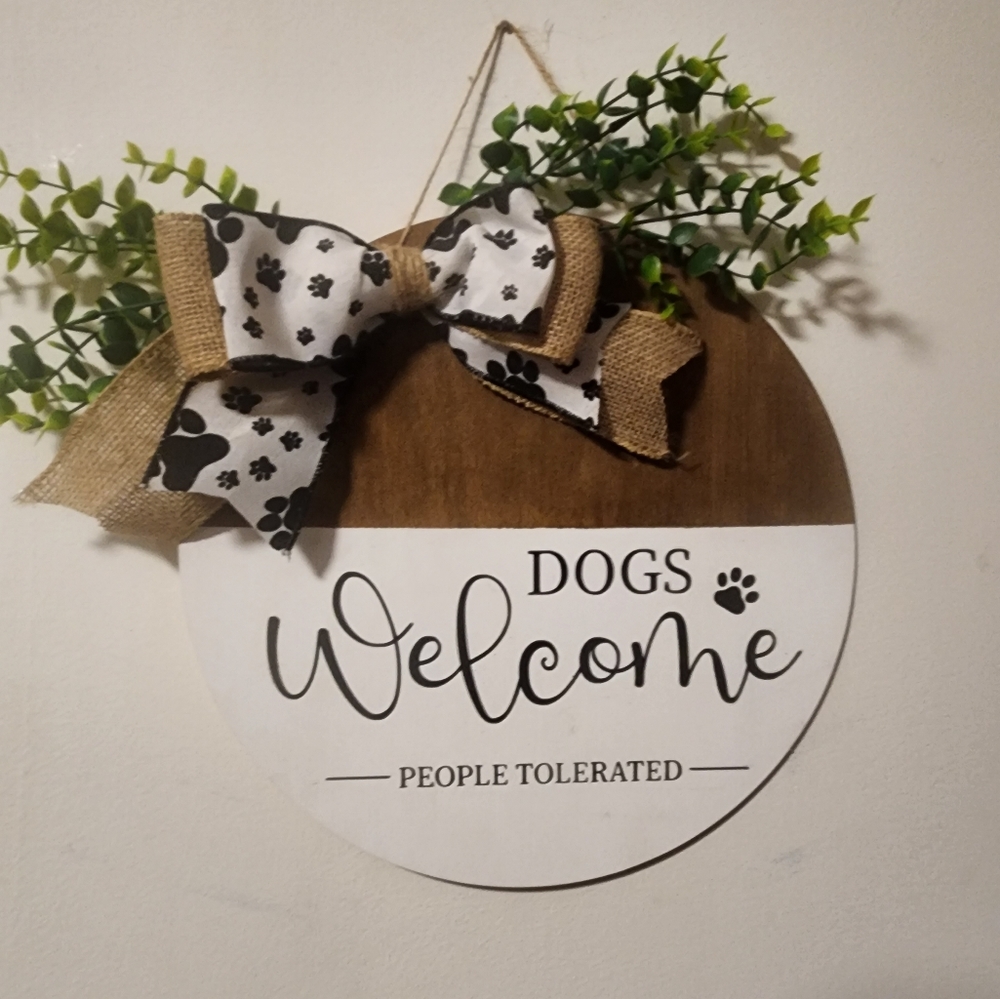 Dogs Welcome People Tolerated wooden round sign 12" with bow and greenery.